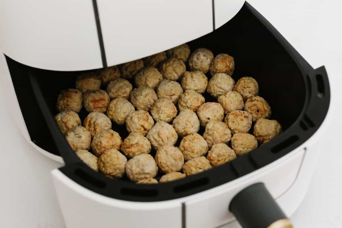 Meatballs spaced out in the air fryer.